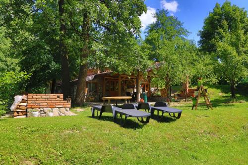 a group of picnic tables and benches in a park at Apartment Green Lagoon in Bihać