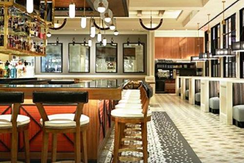 a bar in a restaurant with two stools at Stylish Suite Tampa Minutes to Hard Rock Casino in Tampa