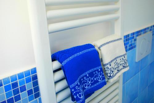 a closet with blue and white towels on a shelf at La Vispa Teresa in Ischia