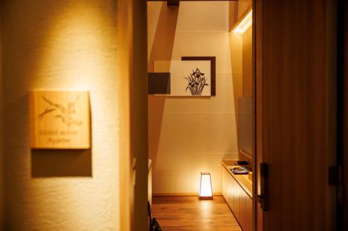 a room with a hallway with a light on the wall at Hotel Kanazawa Zoushi in Kanazawa