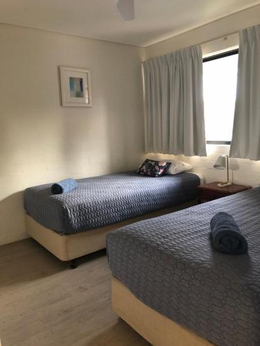 a hotel room with two beds and a window at Apt 42 Riverview Holiday Apartments in Kalbarri