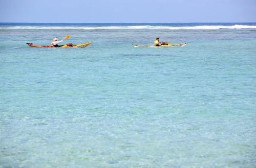 two people in kayaks in the water at Hotel De la Plage in Saint-Gilles les Bains