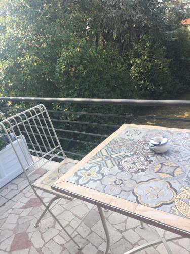 a table and a chair on a patio at B&B La Villa Mediterranea in Passirano
