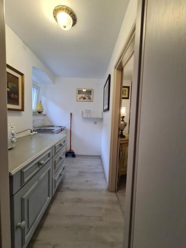 a kitchen with a hallway leading to a room with a sink at Kaya house in Nerežišća