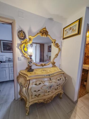a gold bed in a room with a mirror at Kaya house in Nerežišća
