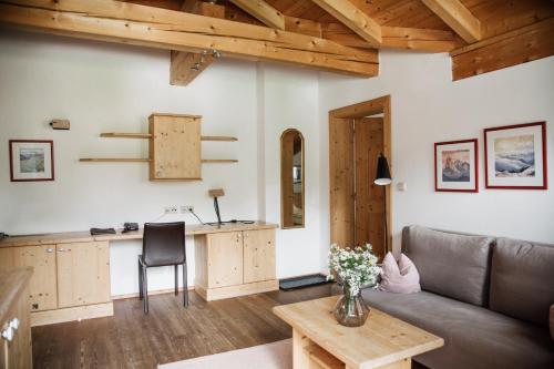 a living room with a couch and a table at Bio-Landpension Monika in Leutasch