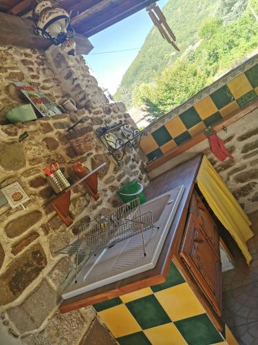 a painting of a kitchen in a stone building at Mes Maisons Gardoises, Two Gites sleeping 13 with Two Private pools, Kids Room, Laundry, Disco, free WiFi, Linen and Dog's are Welcome in Gagnières