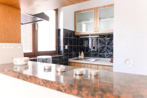 a kitchen with a counter top and a sink at Apartman Greta in Soko Banja