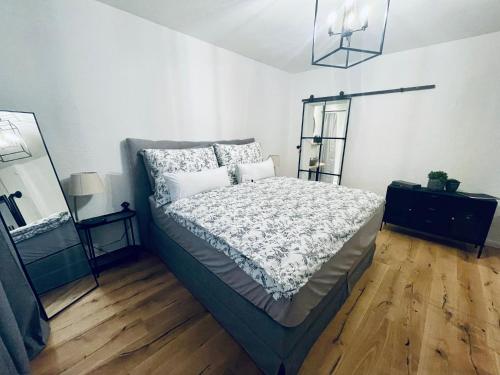 a bedroom with a bed and a dresser and a mirror at Schlafen in der Winzerie in Jois