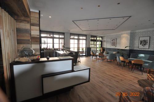 a large room with a kitchen and a living room at Parkhotel Schwedt in Schwedt