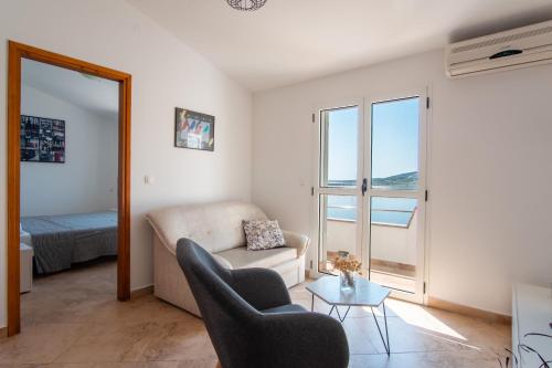 a living room with a couch and a chair at Apartment Lazić Pag by Pag tours in Pag