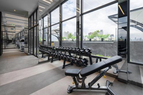 a row of exercise equipment in a gym at Ramada Plaza by Wyndham Bangkok Sukhumvit 48 in Bangkok
