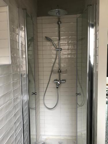 a shower in a bathroom with a glass door at Super studio in Saint-Denis