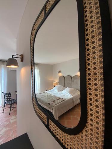 a bedroom with a mirror on the wall at Hôtel l'Arena in Fréjus