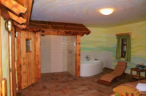 a bathroom with a bath tub in a room at Penzion Kovárna in Bukvice