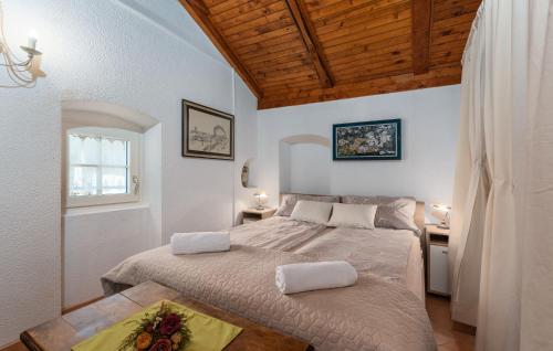 a bedroom with two beds and a wooden ceiling at Villa Lenoir in Vrsar