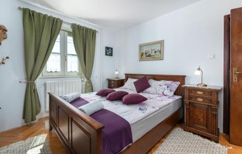 a bedroom with a large bed with purple pillows at Villa Lenoir in Vrsar