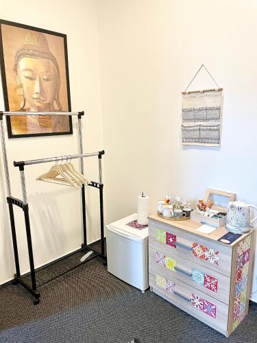 a room with a chest of drawers and a painting at Penzion Villa Amélie in Mladá Boleslav