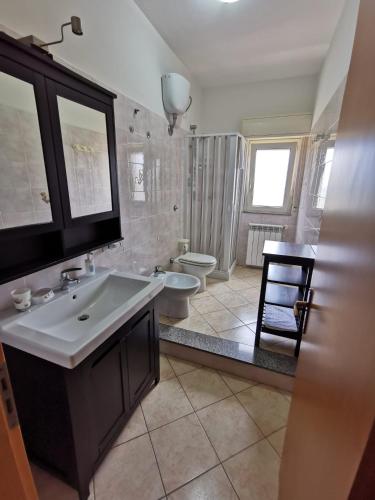 a bathroom with a sink and a toilet at Scala dei Turchi Apartment in Realmonte