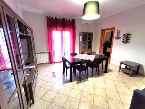 a kitchen and dining room with a table and chairs at Scala dei Turchi Apartment in Realmonte