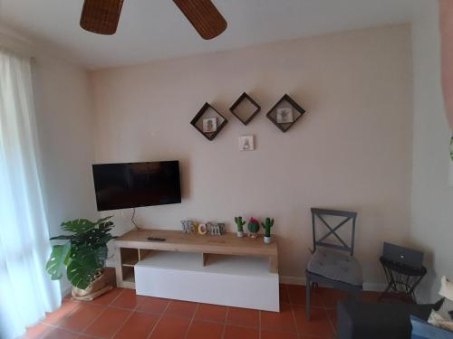 a living room with a table and a tv on the wall at Le Panchette _ Pool & Bike in Salionze
