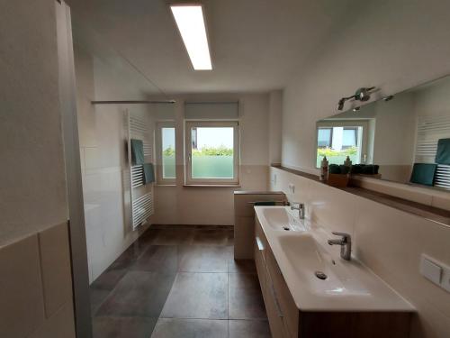 a bathroom with a sink and a mirror at Ferienhaus Zum Prinzenkopf in Alf