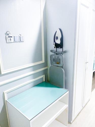 a stool in a room with a mirror on the wall at 61 Hotel in Gua Musang