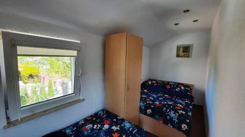 a small bedroom with a bed and a window at Domek Ewa in Giżycko