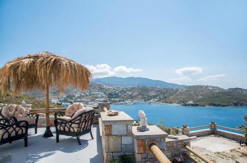 a patio with chairs and a view of the water at Ios stylish house Panoramic Sea and Sunset view in Ios Chora