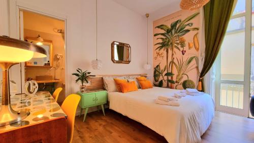 a bedroom with a bed with orange pillows and a table at Napoli Tree - Lungomare in Naples