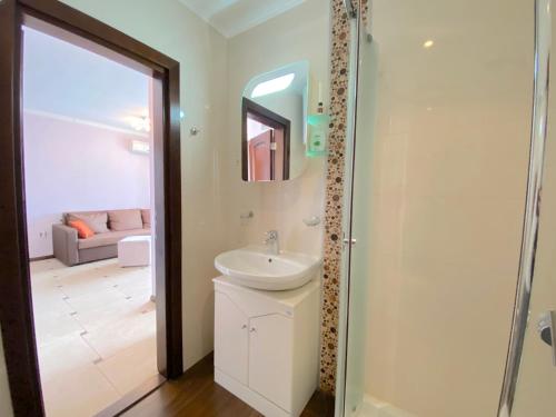 a bathroom with a sink and a mirror at Tryavna Beach - Private Apartment - BSR in Sveti Vlas