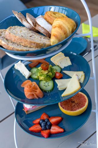 two blue plates with different types of food on them at Rue Haute by M&M 4 sterren bed en breakfast vlakbij Maastricht in Eben-Emael