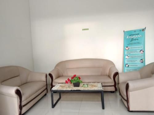 a waiting room with two couches and a table at GRAND TOBA HOTEL in Balige