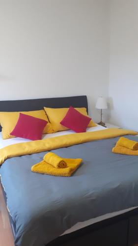 - un lit avec des serviettes et des oreillers jaunes dans l'établissement Oaza Klara, à Karlovac