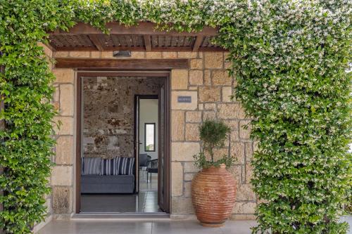 an entrance to a building with a large vase at Tramonto Suites in Xi
