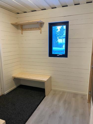 a room with a bench in front of a window at 1125 Fjällstugan in Lofsdalen