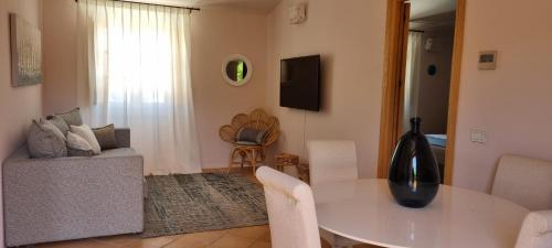 a living room with a white table and a couch at Hotel Borgo Smeraldo in Arzachena