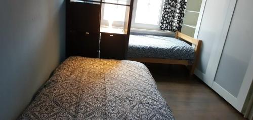 a small room with two beds and a window at ROOM WITH 2 SEPARATED BEDS in Mortsel