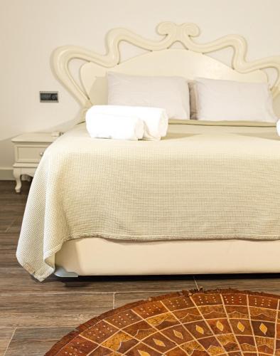 a bedroom with a white bed with white pillows at Casa Di Pietra in Fethiye