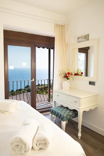 a bedroom with a desk and a view of the ocean at Casa Di Pietra in Fethiye