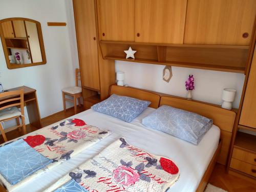 a bedroom with two beds with blue pillows at Villa Libe in Baška Voda