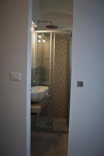 a bathroom with a sink and a glass shower at Da Mariolino in Numana