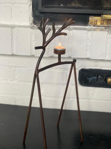 a candle holder with a deer head on it at 1125 Fjällstugan in Lofsdalen