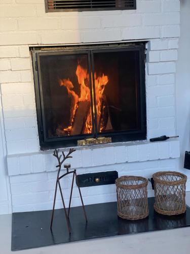 a fireplace with two baskets in front of it at 1125 Fjällstugan in Lofsdalen