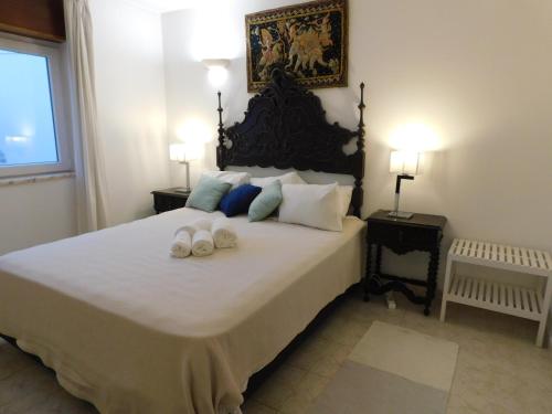 a bedroom with a large bed with two shoes on it at Luz Beach Center in Luz