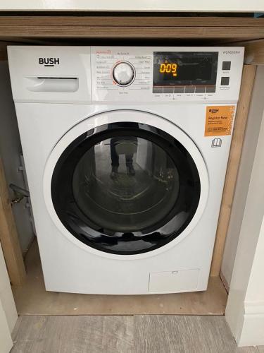 a white washing machine sitting in a room at Small Single room walking distance to Hove Station in Brighton & Hove