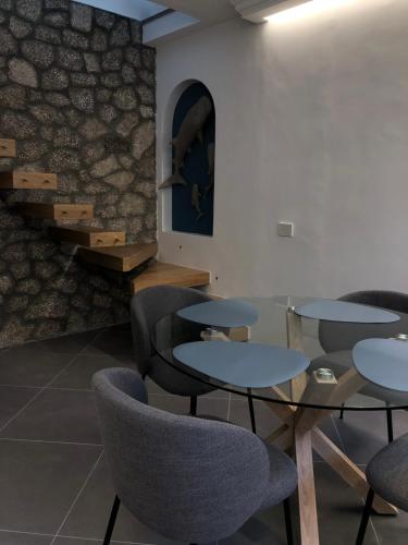 una habitación con mesas y sillas y una escalera en Casa Flavia, en Anacapri