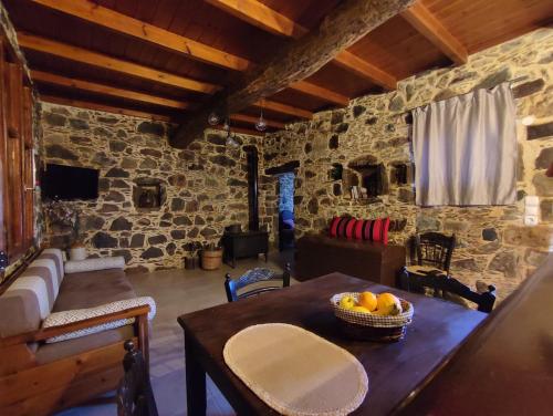 ein Zimmer mit einem Tisch und einer Obstschale darauf in der Unterkunft Grandma Agatha & Virginia's stonehouse in Kefálion