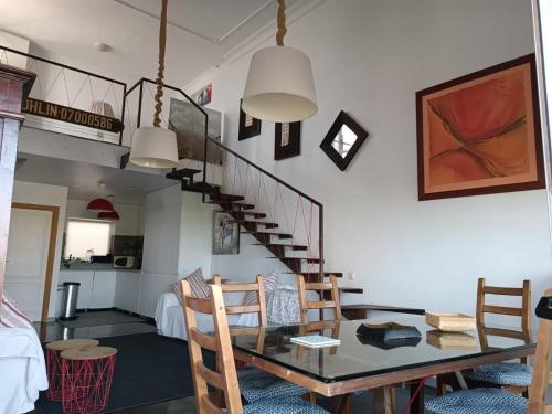 a dining room with a table and a staircase at CASA NAOS in Arrecife