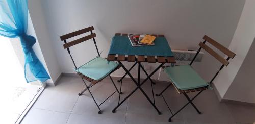 a small table with two chairs and a book on it at Apartment Katrin im Zentrum in Bad Ischl